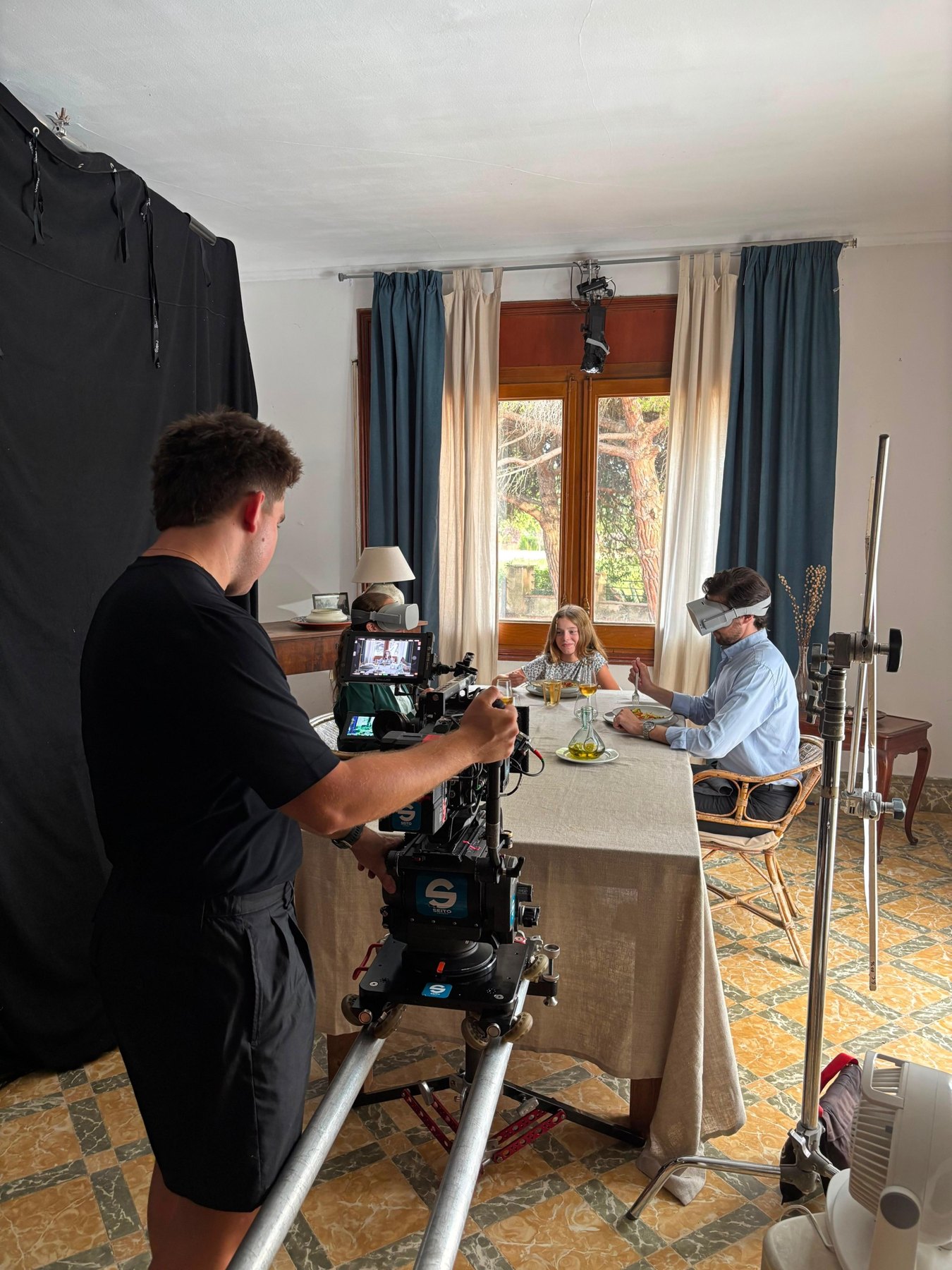 Camera operator on a dolly filming the family dinner